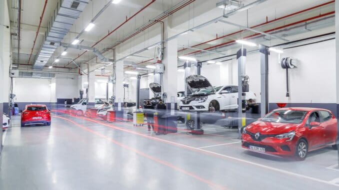Bright, clean garage workshop with cars on the ramps