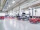 Bright, clean garage workshop with cars on the ramps
