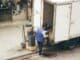 Man loading boxes from the back of a delivery lorry