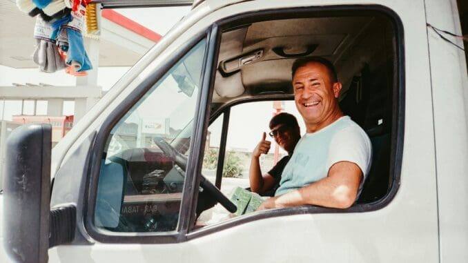 Smiling van driver giving a thumbs up from the cab