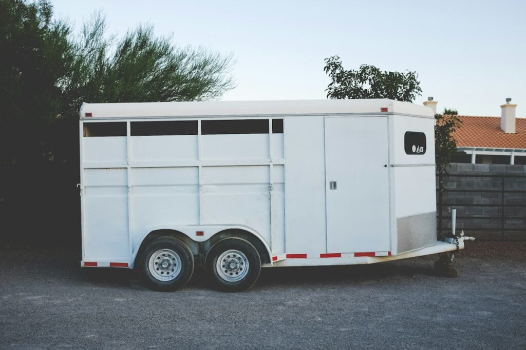 White enclosed trailer parked on a driveway