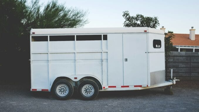 White enclosed trailer parked on a driveway