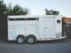 White enclosed trailer parked on a driveway