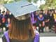Graduate seen from behind wearing a mortarboard at a ceremony