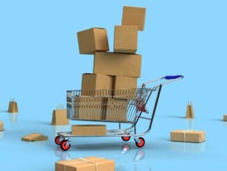 Toy shopping trolley piled with small cardboard parcels on a blue background