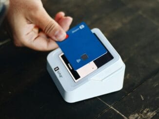 Customer paying by card on a card reader