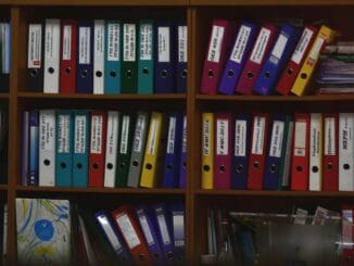 Shelves of colourful ring binders in an office