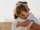 Young child hugging a parent