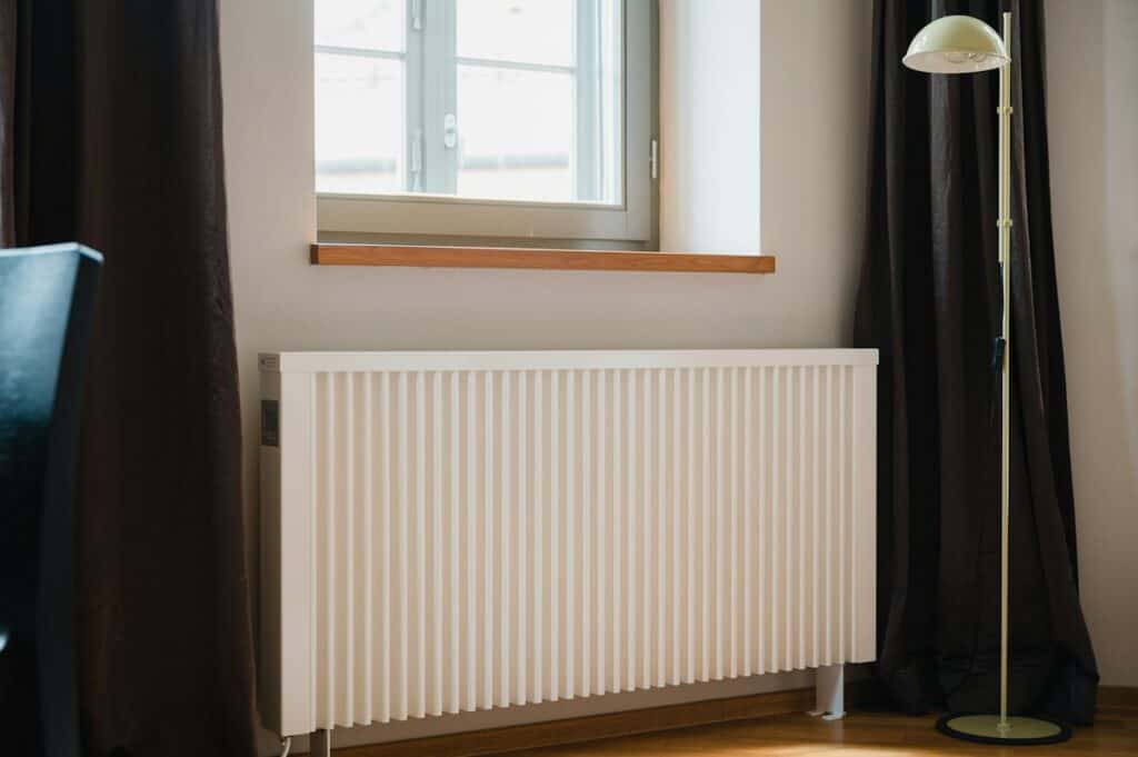 White radiator under a window in a living room