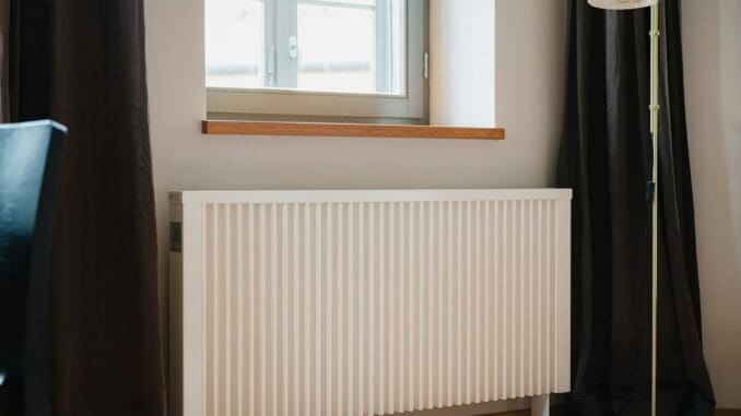 White radiator under a window in a living room