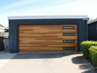 Modern wooden garage door on a dark-clad garage