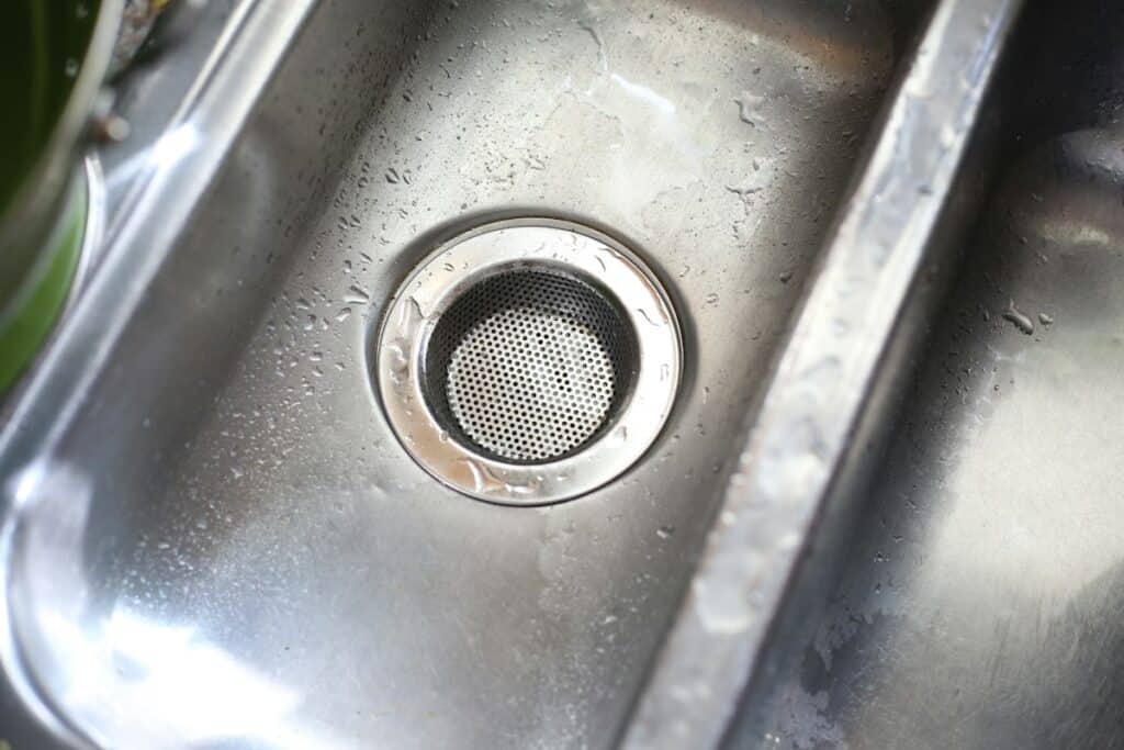 Close-up of a stainless steel kitchen sink drain