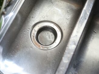 Close-up of a stainless steel kitchen sink drain