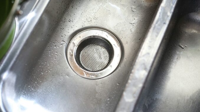 Close-up of a stainless steel kitchen sink drain