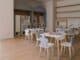 Empty nursery playroom with small white tables and chairs