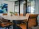 Meeting room with an oval wooden table and orange chairs
