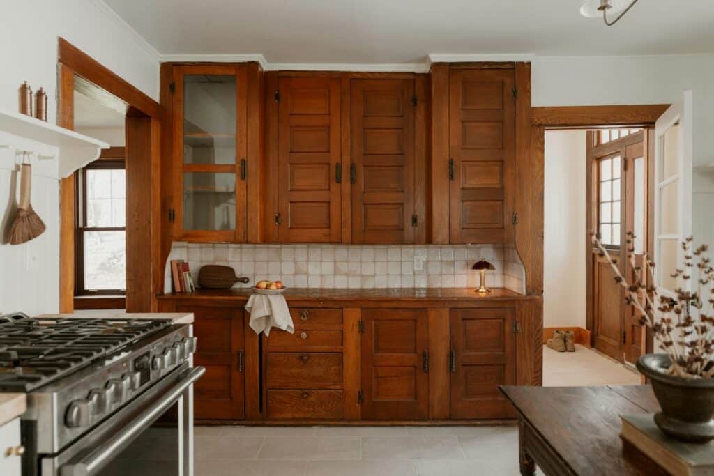 Kitchen with dark wooden cabinets and a stone floor