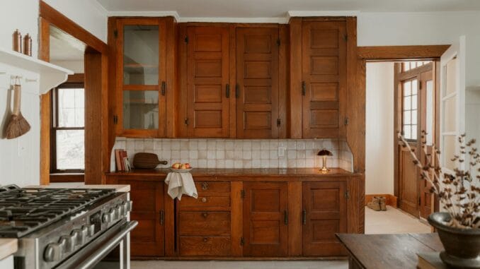 Kitchen with dark wooden cabinets and a stone floor