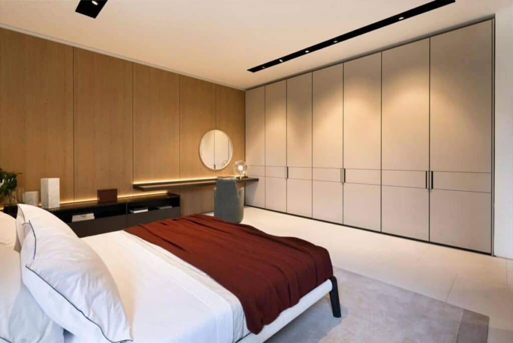Handleless fitted wardrobe doors in a modern bedroom