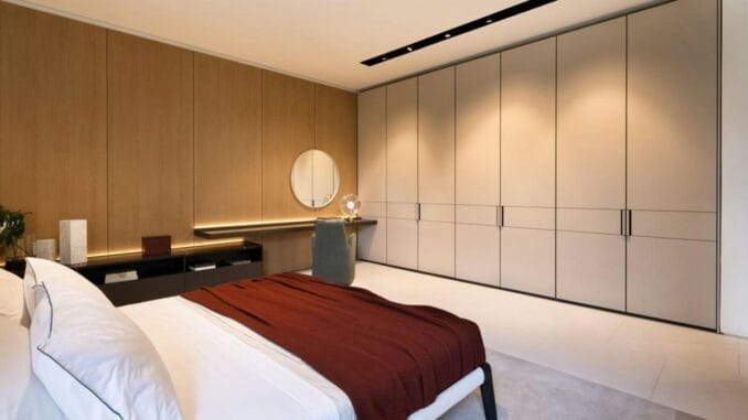 Handleless fitted wardrobe doors in a modern bedroom