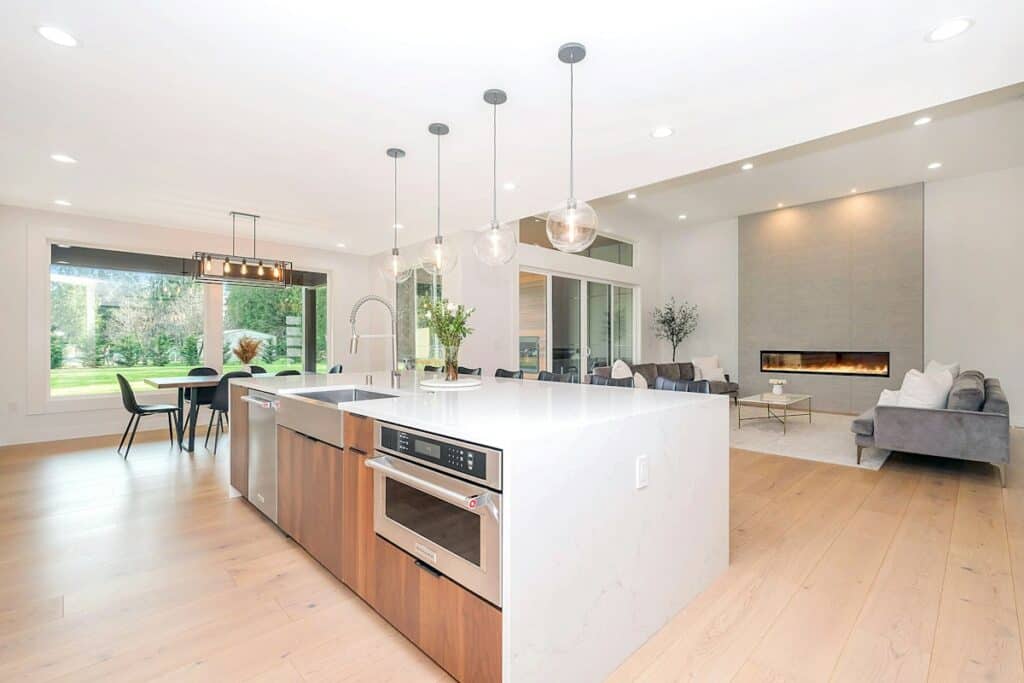 Bright open-plan kitchen with a white island and pendant lights